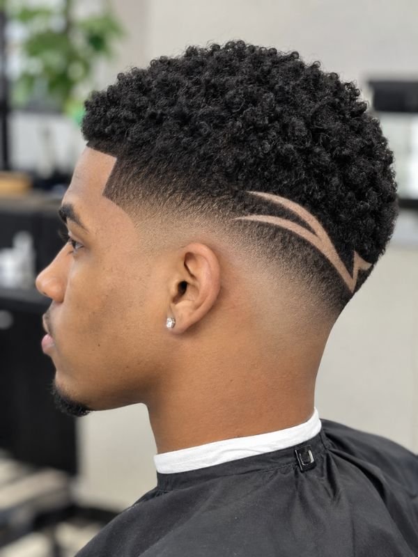 3. Low Taper Fade Black Haircut with Design